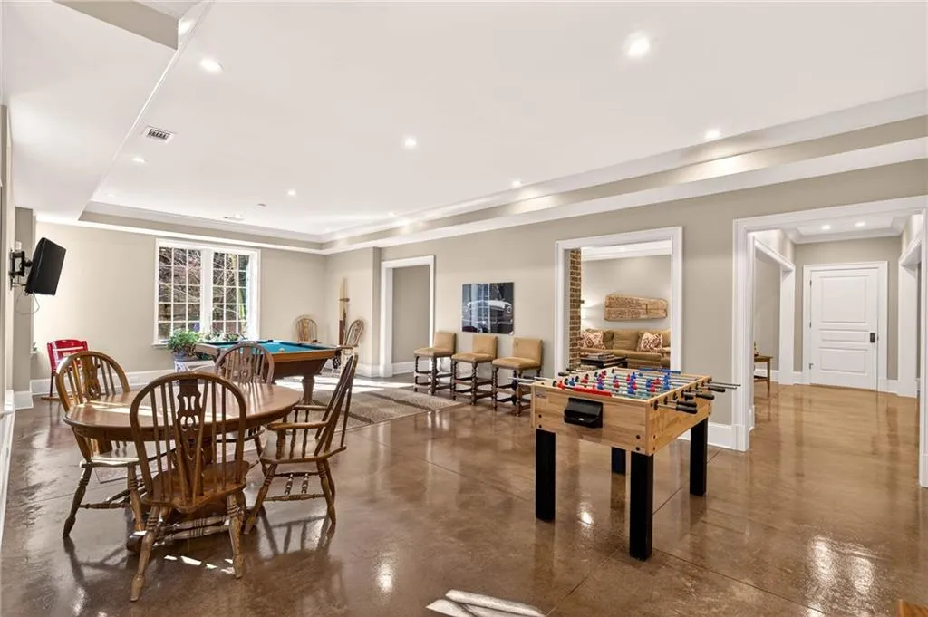 Playroom featuring concrete floors, recessed lighting, pool table, and a tray ceiling