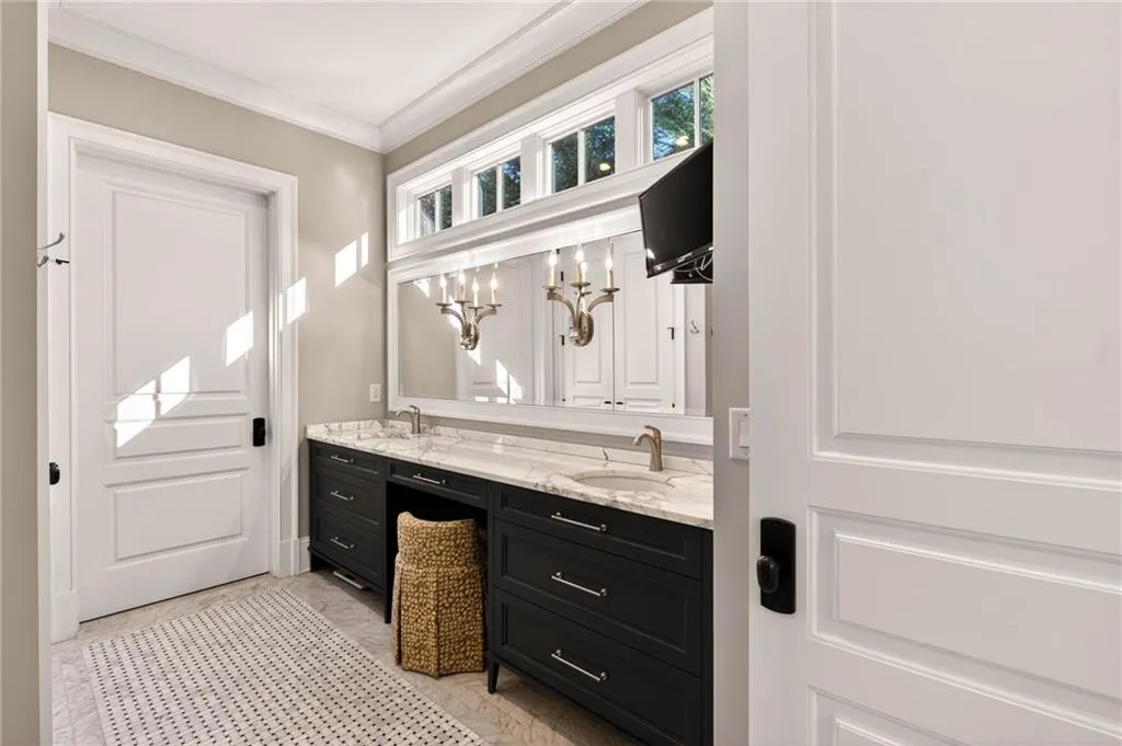 Bathroom with ornamental molding and double vanity