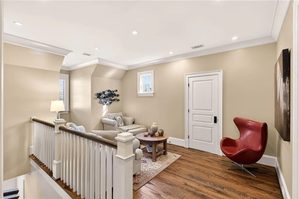 Living area featuring crown molding, recessed lighting, and dark wood-type flooring