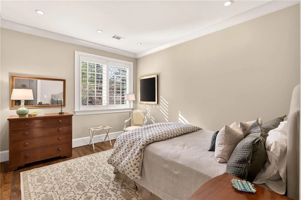 Bedroom featuring wood finished floors, ornamental molding, and recessed lighting