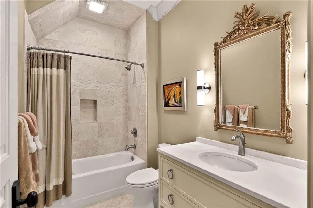 Bathroom with vanity and shower / bath combination with curtain
