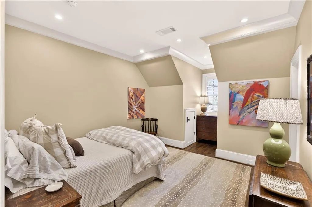 Bedroom with ornamental molding, wood finished floors, recessed lighting, and lofted ceiling