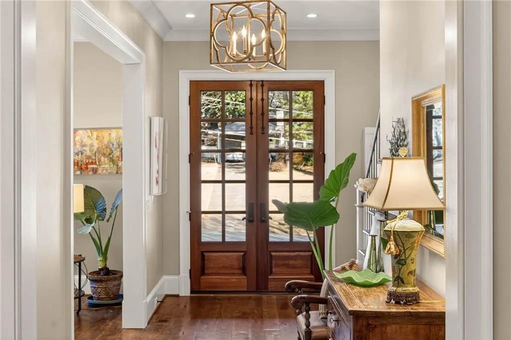 Doorway featuring french doors, ornamental molding, hardwood / wood-style flooring, a chandelier, and recessed lighting