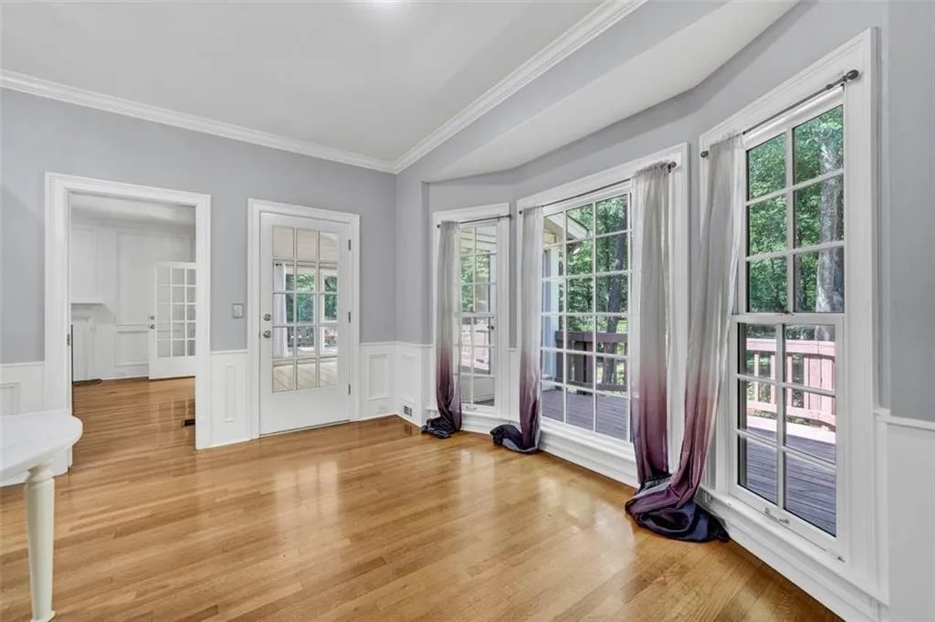 Doorway to outside featuring ornamental molding, plenty of natural light, and light wood-type flooring