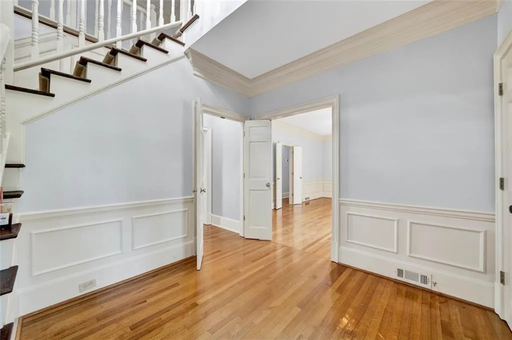 Empty room with light hardwood / wood-style flooring and crown molding