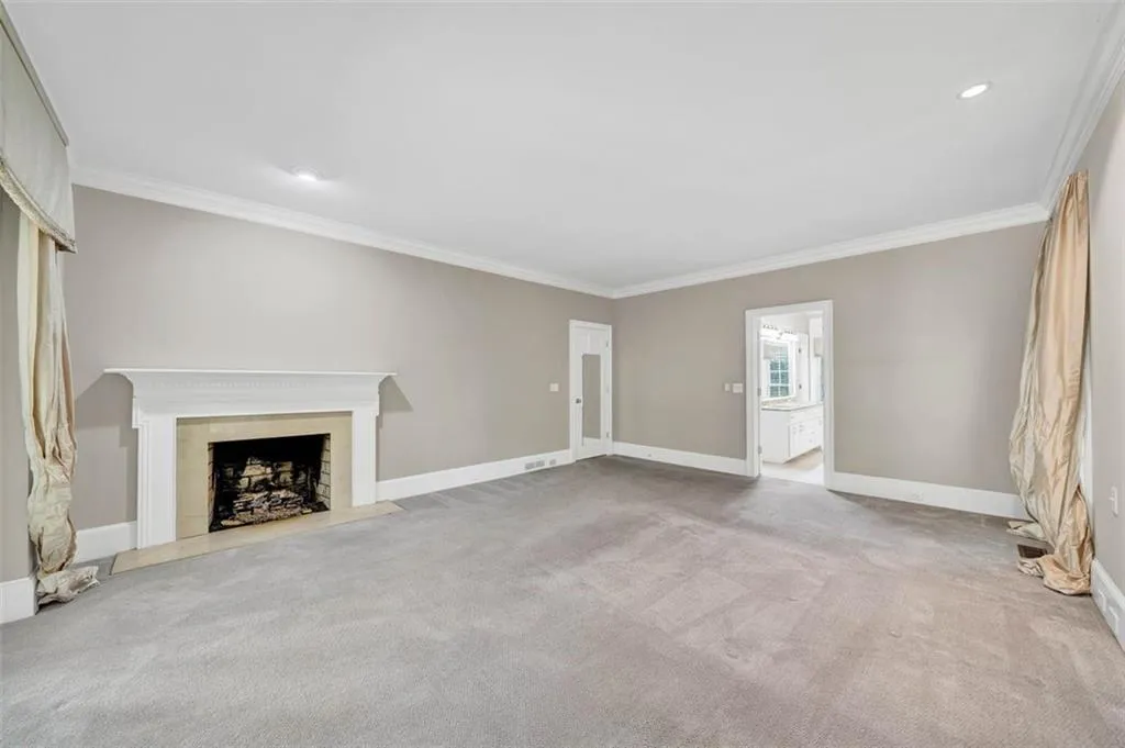 Unfurnished living room with ornamental molding and carpet flooring