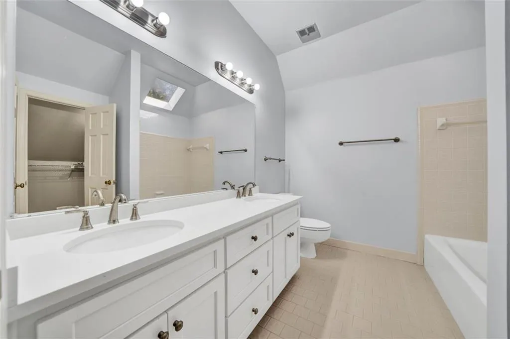 Hall with crown molding and light carpet