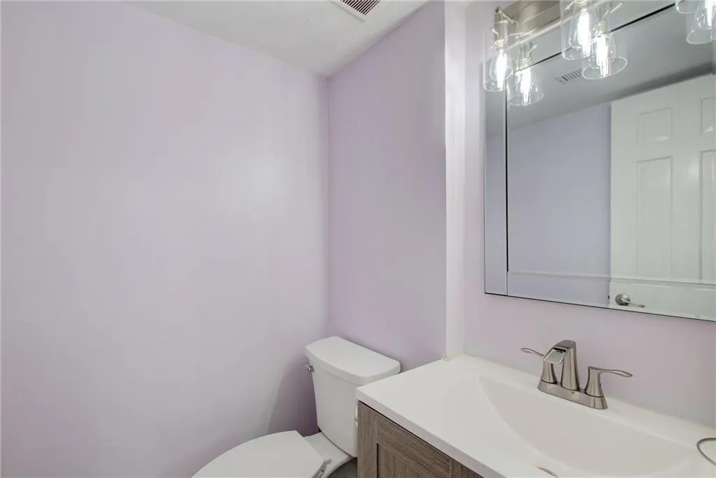 Half bath featuring vanity and toilet