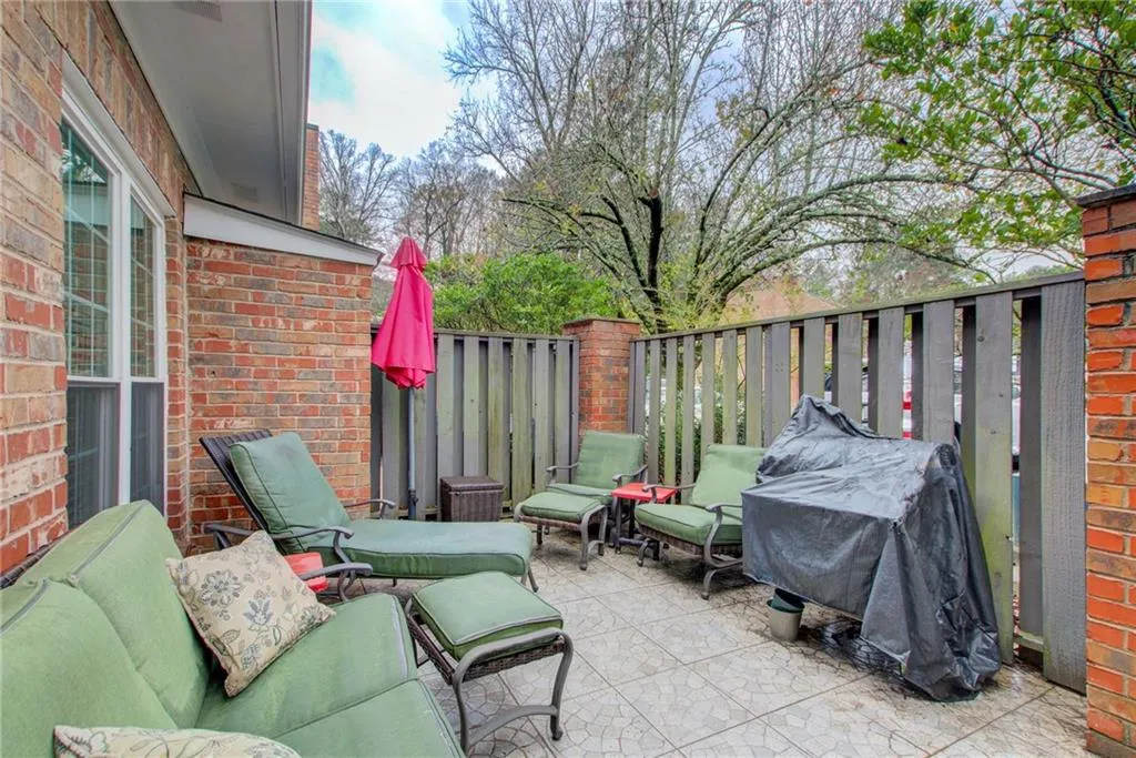Fenced backyard with grilling area and a patio area