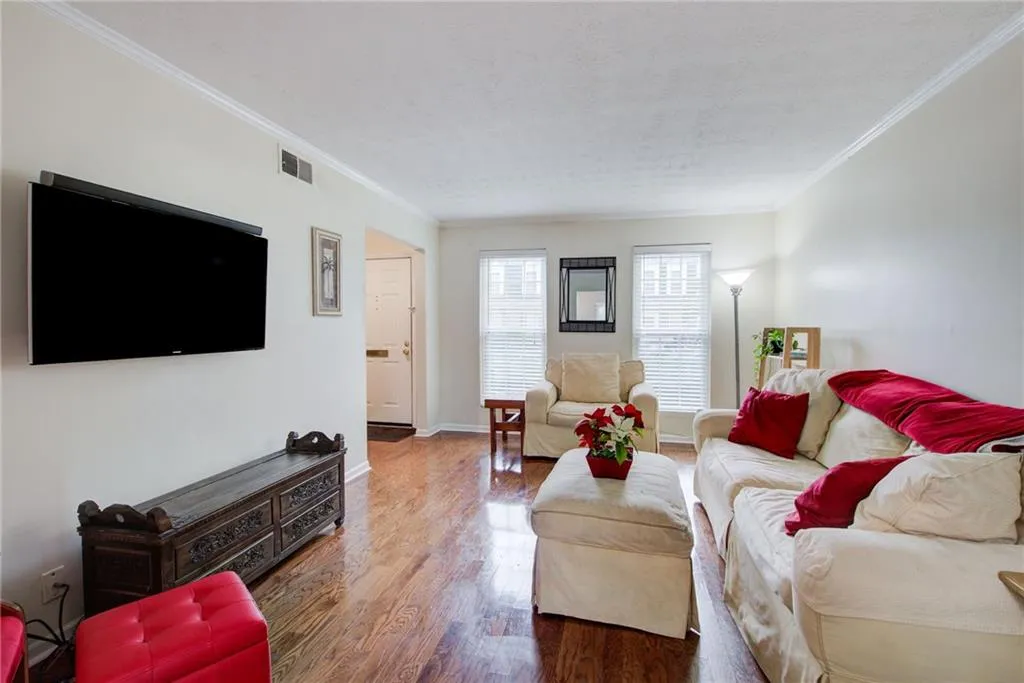 Living area with wood finished floors, view to front entry foyer