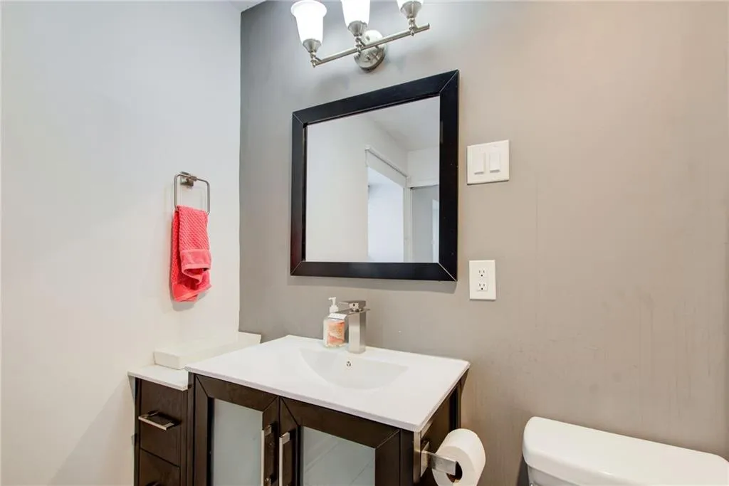 Bathroom featuring a chandelier and vanity