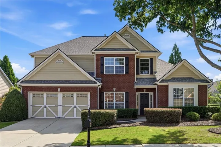 Brick front with concrete-fiber siding.