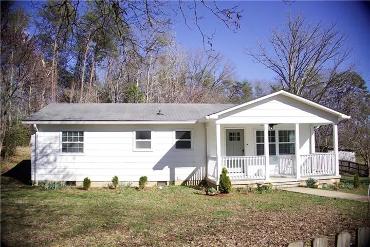 Ranch-style house with a porch, crawl space, and a front lawn