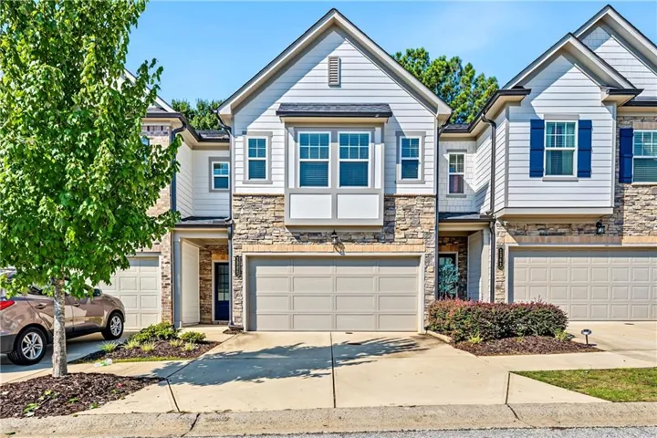 Stone and siding exterior with a two-car garage