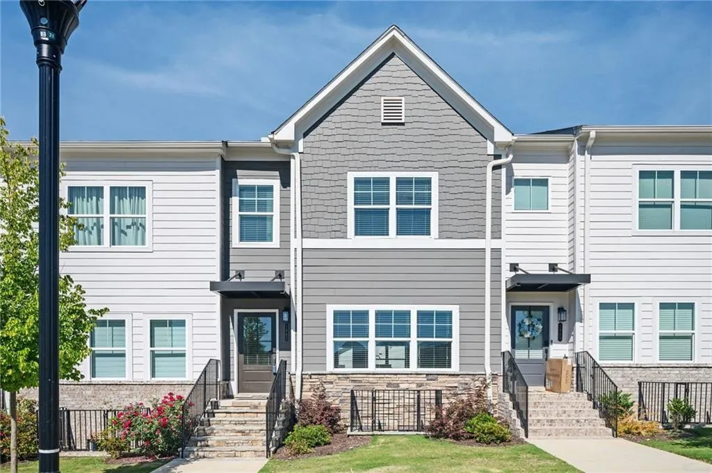 View of front facade featuring stone siding and a front yard