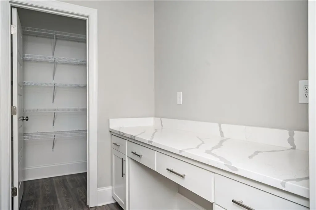 Bathroom featuring vanity and dark wood-type flooring