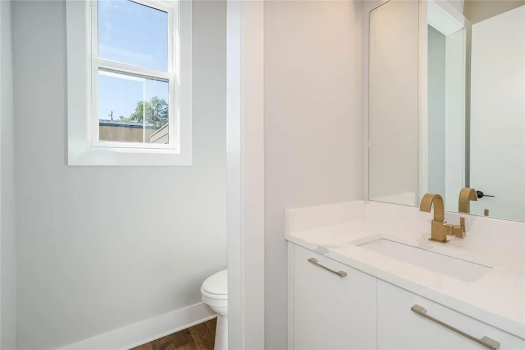 Bathroom featuring toilet, vanity, and hardwood / wood-style flooring