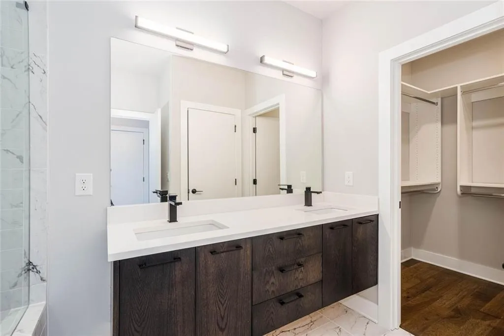 Bathroom featuring dual bowl vanity and hardwood / wood-style floors