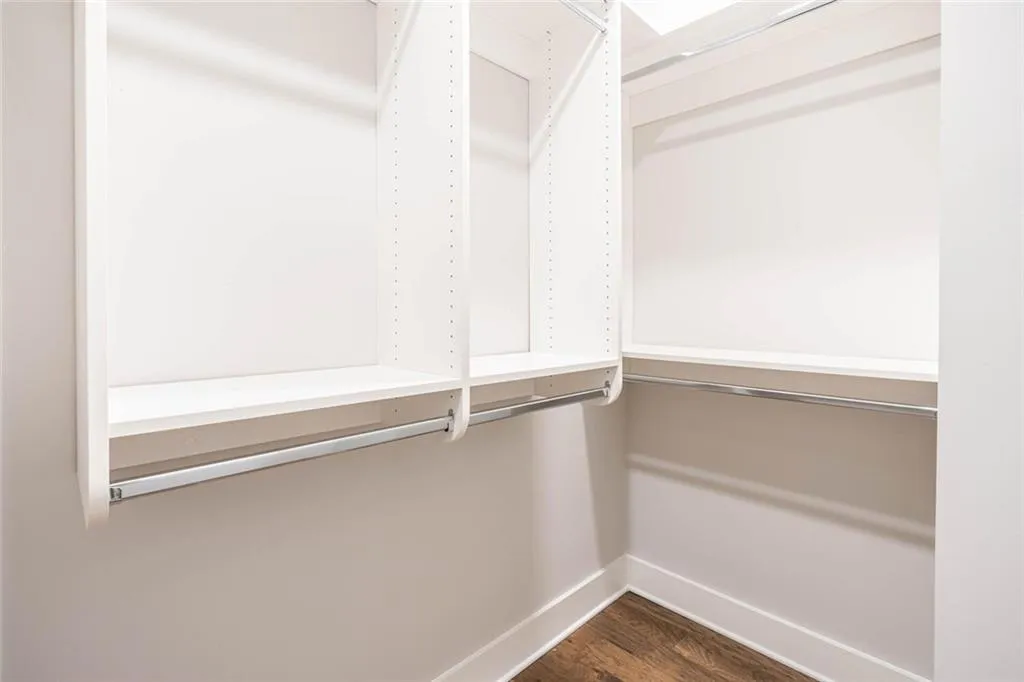 Walk in closet featuring dark hardwood / wood-style floors