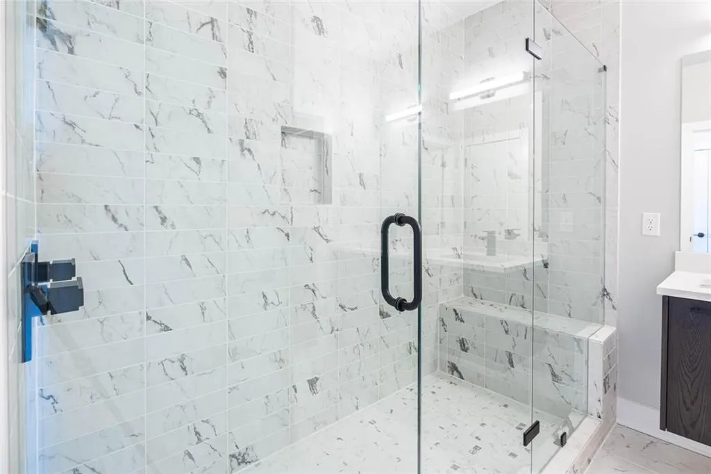 Bathroom with a shower with shower door and vanity