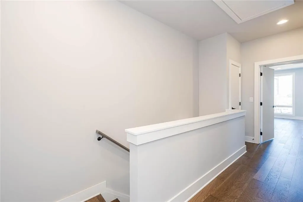 Corridor with dark hardwood / wood-style floors