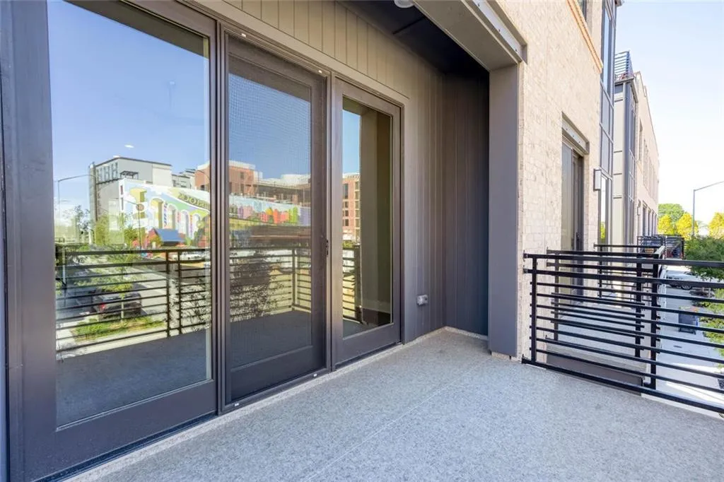 View of exterior entry with a balcony