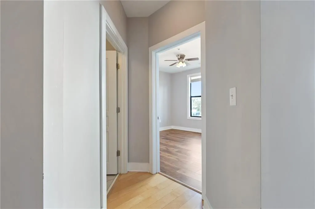 Hallway featuring baseboards and light wood-style floors