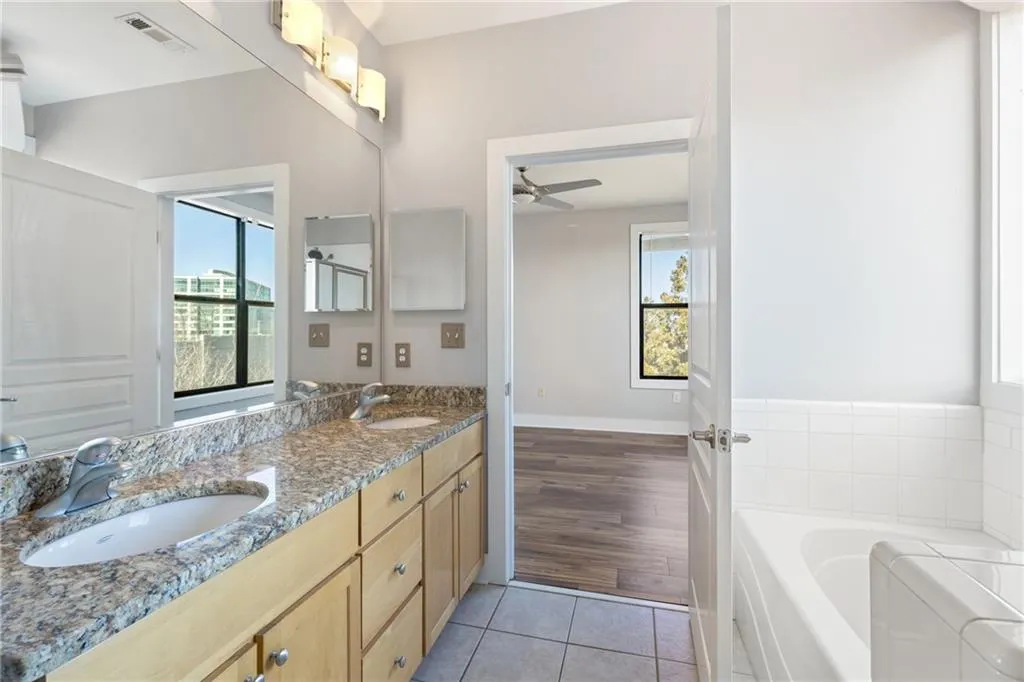 Full bathroom with a bath, tile patterned flooring, a sink, and visible vents