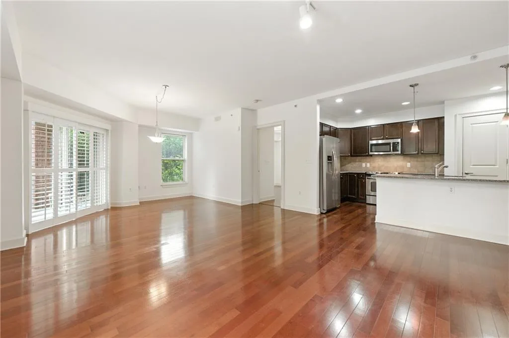 Unfurnished living room with dark wood finished floors and recessed lighting