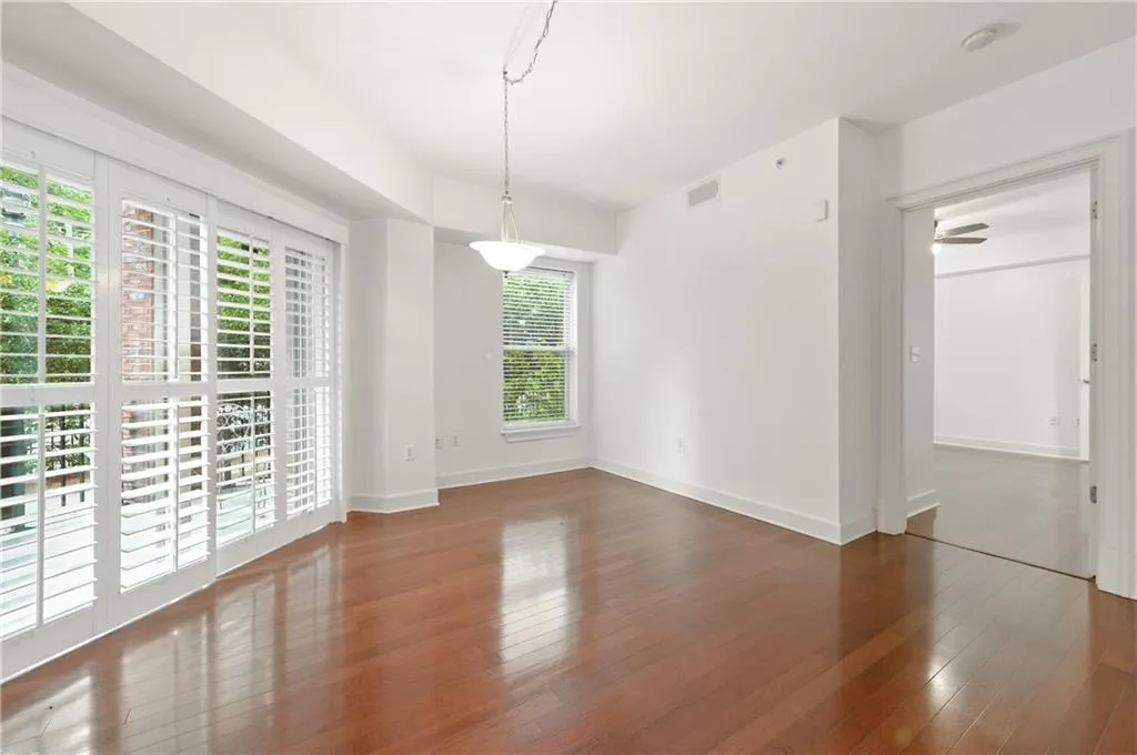 Spare room with dark wood-style flooring and a ceiling fan