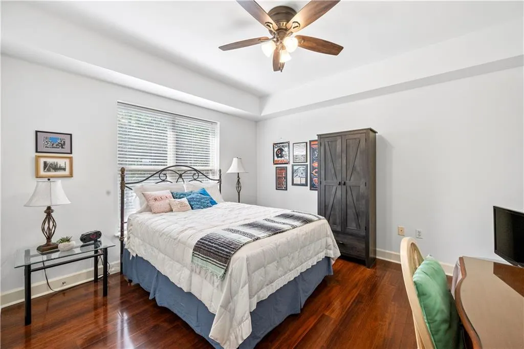 Bedroom featuring wood finished floors and a ceiling fan