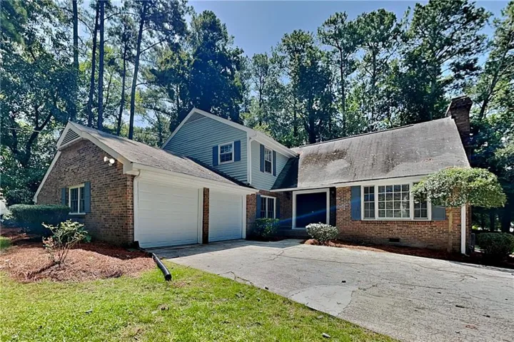 Brick and siding exterior with a two-car garage