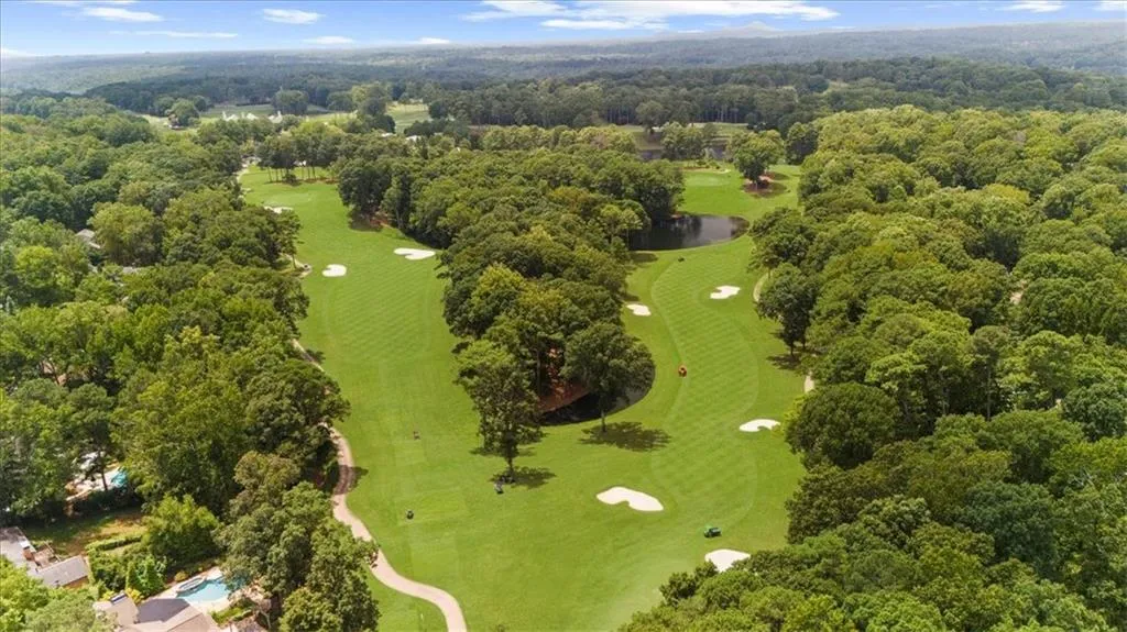 Drone / aerial view of a large body of water and a local golf course