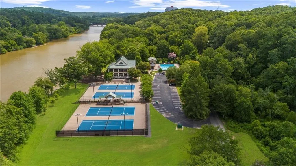 Aerial view of a heavily wooded area and a nearby body of water