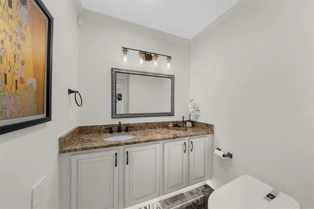 Bathroom featuring vanity and ornamental molding