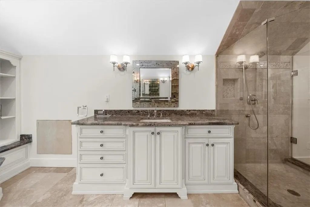 Full bathroom featuring a stall shower and vanity