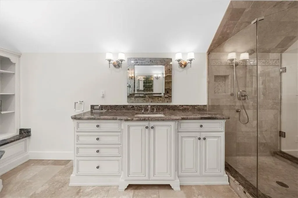 Bathroom featuring a shower stall and vanity