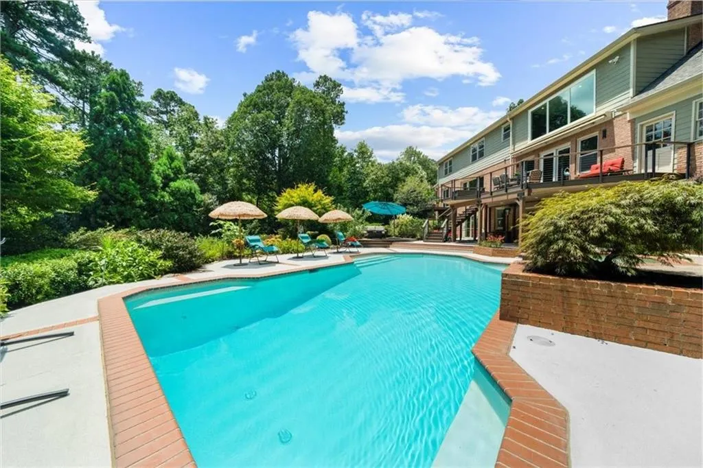 Outdoor pool featuring stairway and a patio area