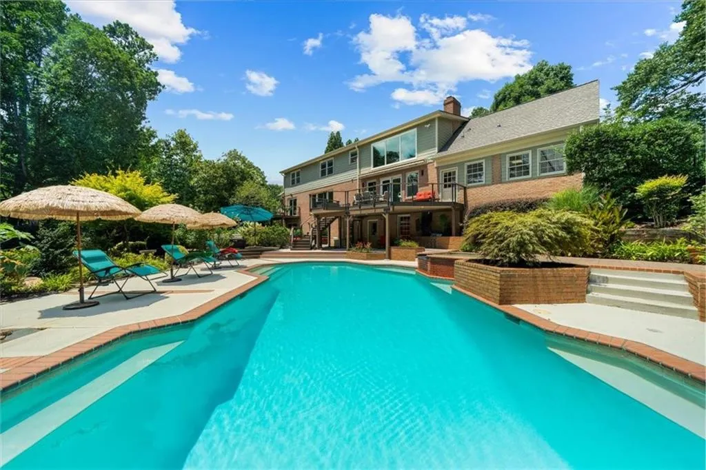 Outdoor pool featuring stairs, a deck, and a patio