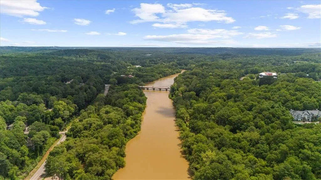 Aerial view of a heavily wooded area and a large body of water