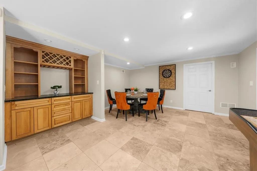 Dining space featuring recessed lighting and ornamental molding