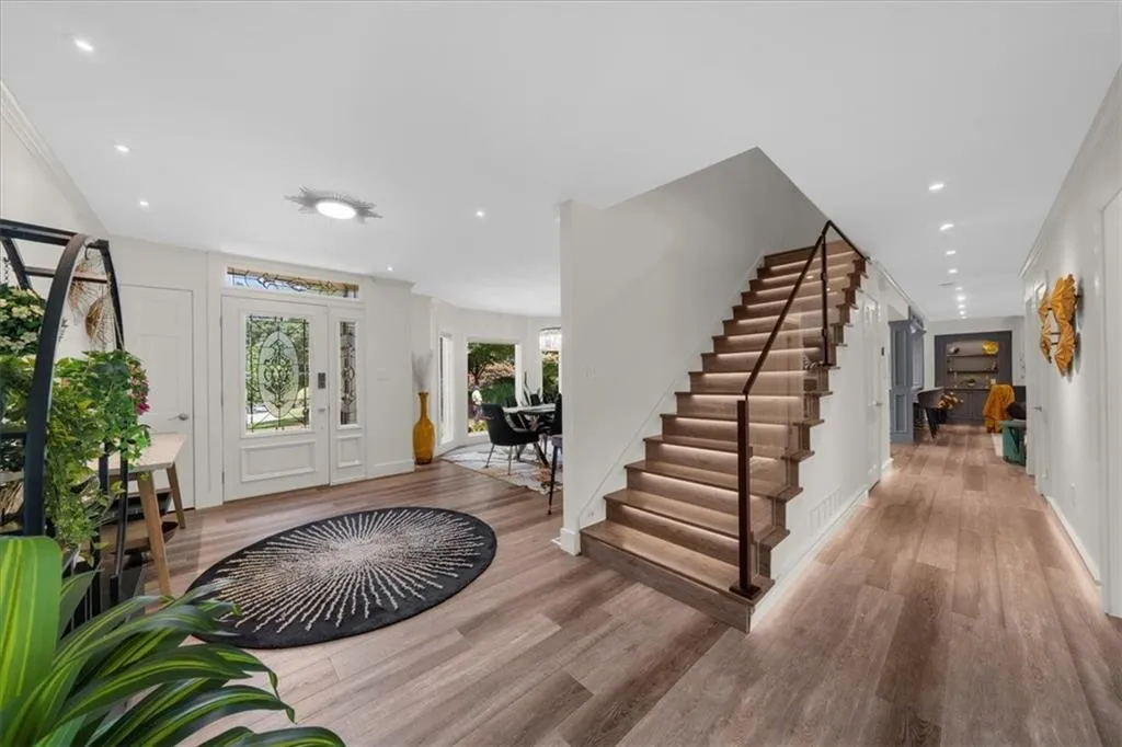 Foyer featuring ornamental molding, stairs, light wood-type flooring, and recessed lighting