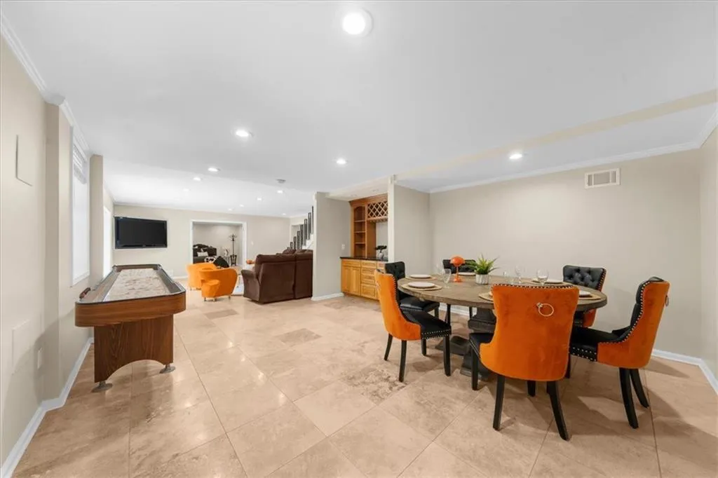 Dining room featuring ornamental molding, recessed lighting, and light tile patterned floors