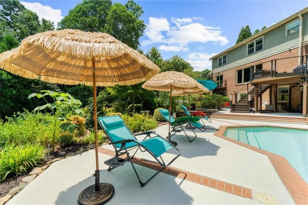 Swimming pool featuring stairway and a patio area