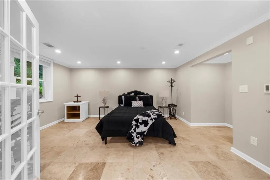 Bedroom with ornamental molding and recessed lighting