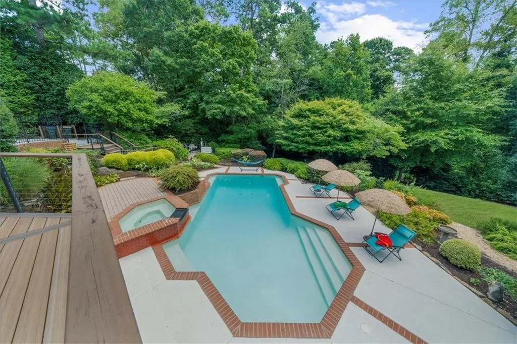 View of swimming pool with a patio area and a pool with connected hot tub