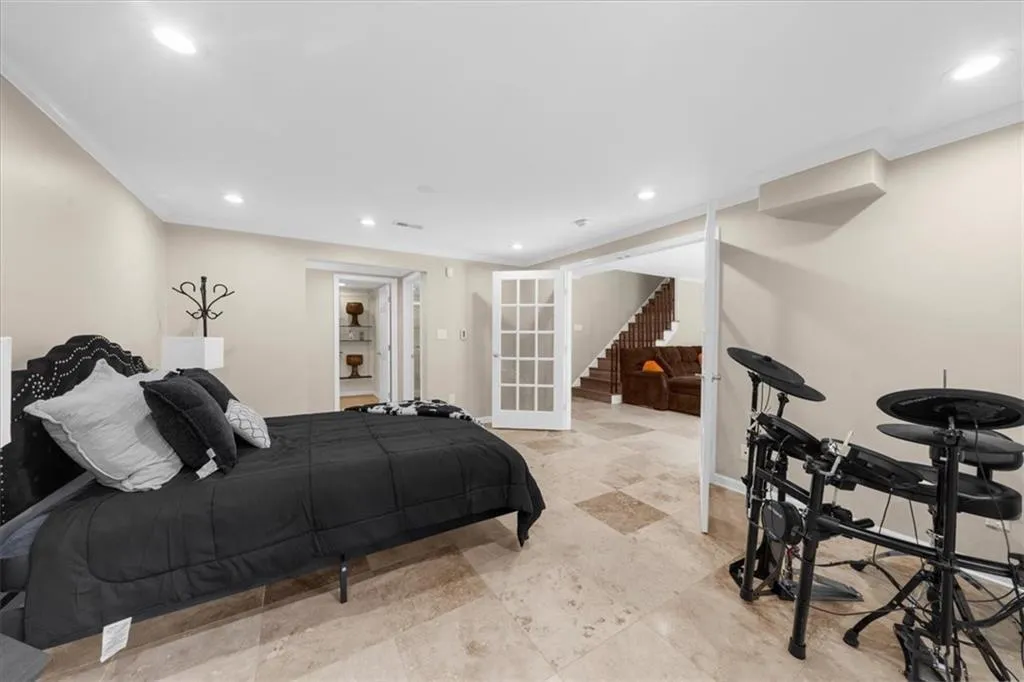 Bedroom with crown molding and recessed lighting