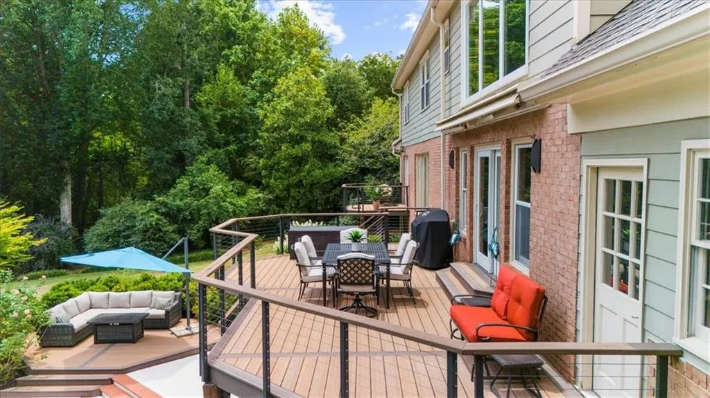 composite deck featuring outdoor dining space, an outdoor hangout area, and area for grilling