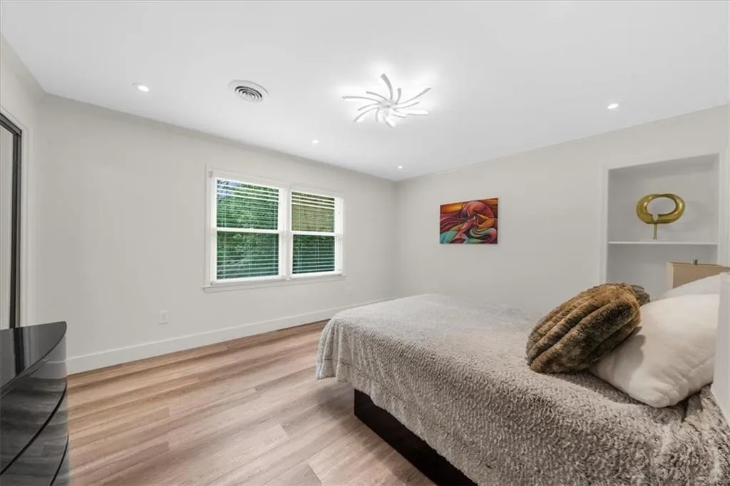 Bedroom with light wood-style floors and recessed lighting