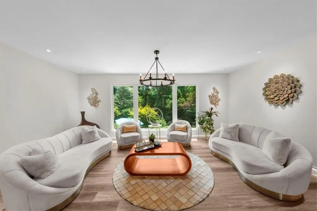Living area with a chandelier, light wood finished floors, and recessed lighting